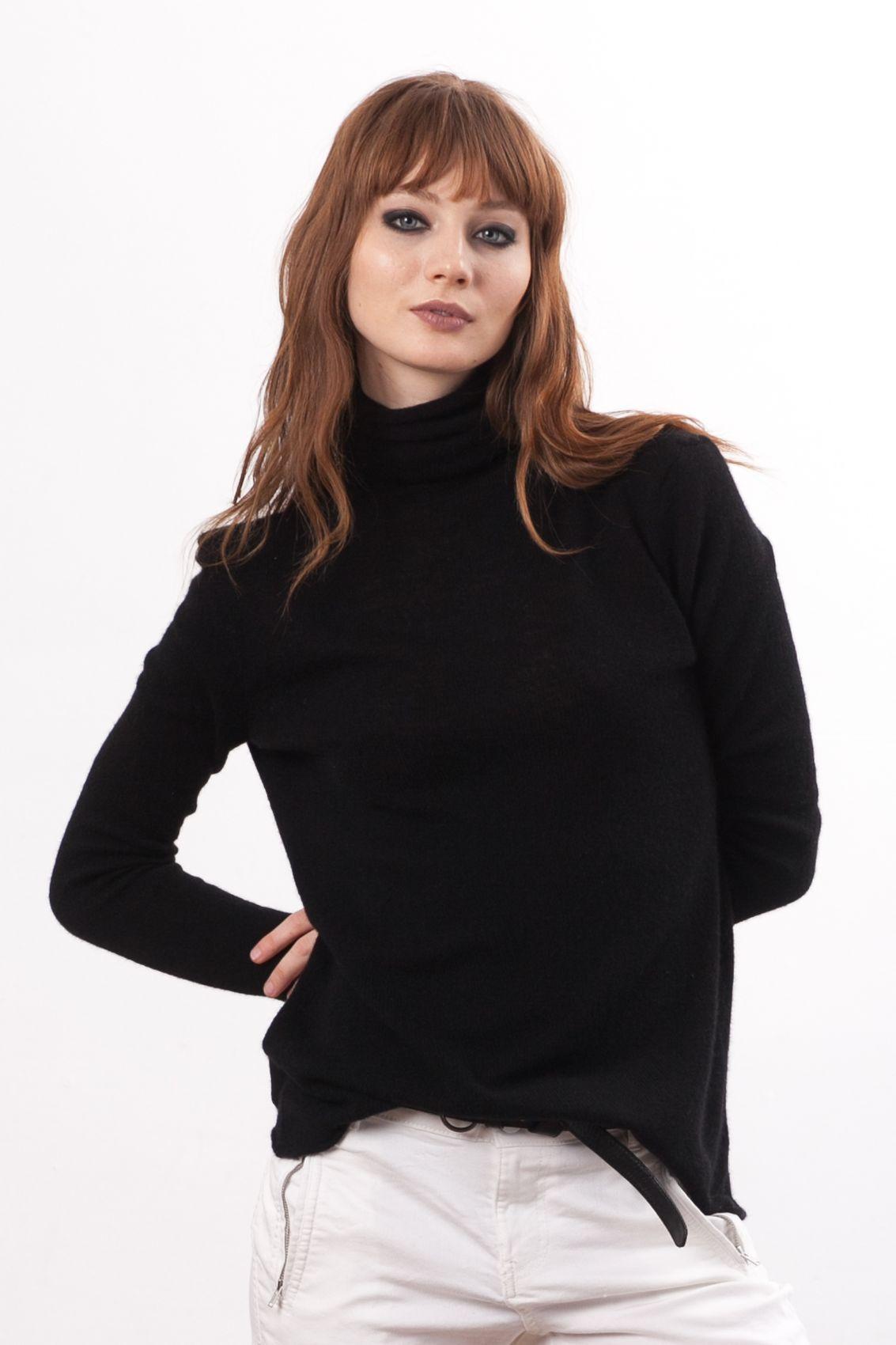 In this elegant image, the KATE by Krista Elsta black cashmere turtleneck takes center stage, showcasing a perfect blend of luxury and style. The rich black hue of the cashmere fabric accentuates the timeless design, offering a cozy and sophisticated look. The turtleneck's snug fit gracefully enhances the silhouette, making it a versatile wardrobe essential for any fashion-forward individual