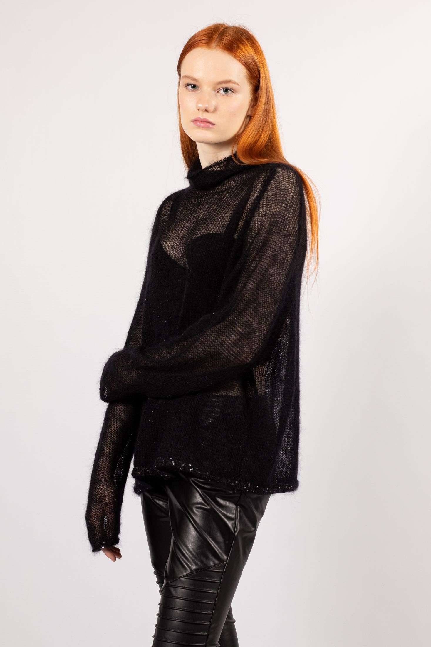 Embrace the allure of transparency with our women's black mohair sweater, a winter essential designed with long sleeves for both fashion and warmth.