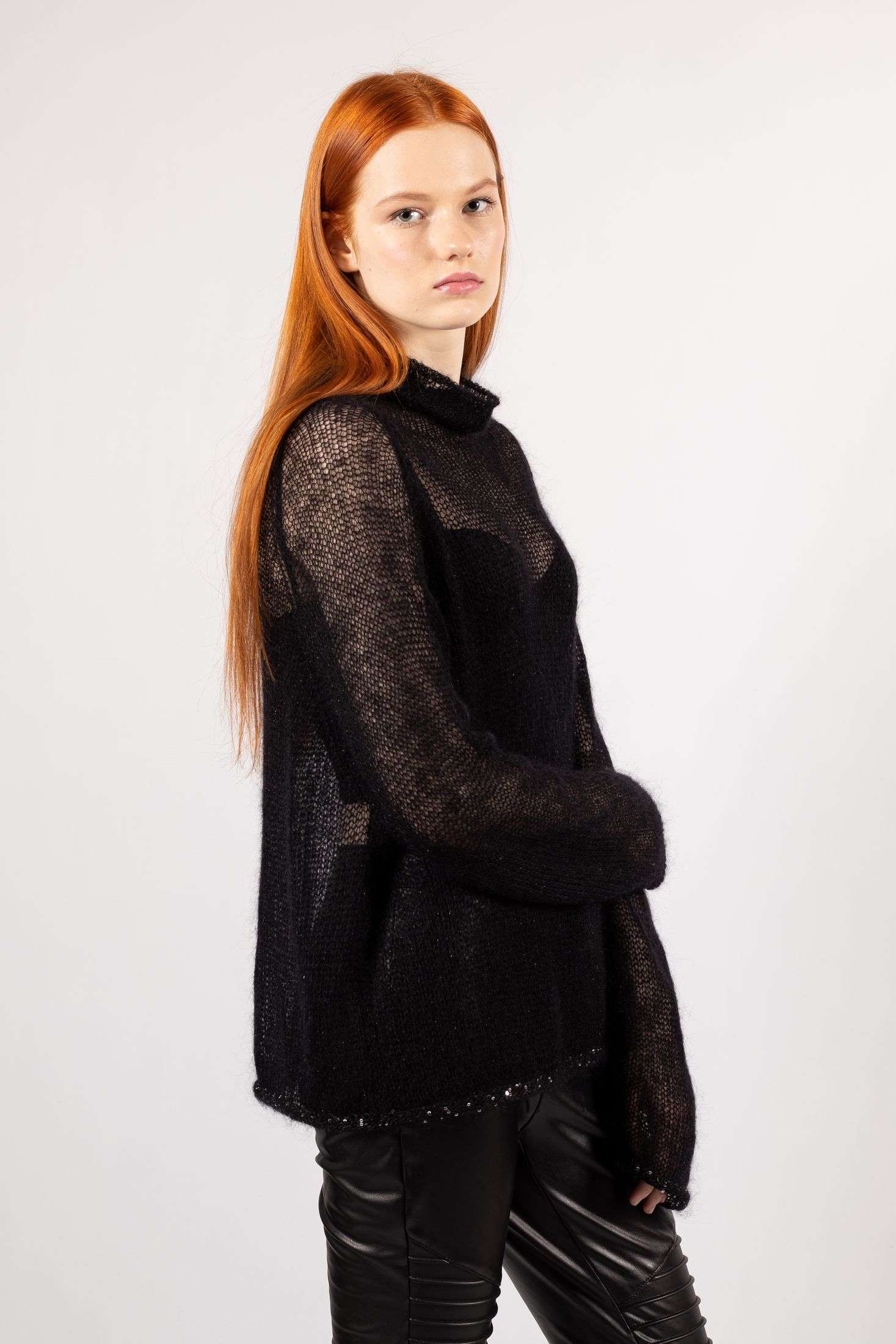 Make a statement with our women's black mohair sweater, a must-have fashion piece with long sleeves and a hint of transparency for that effortlessly chic look.