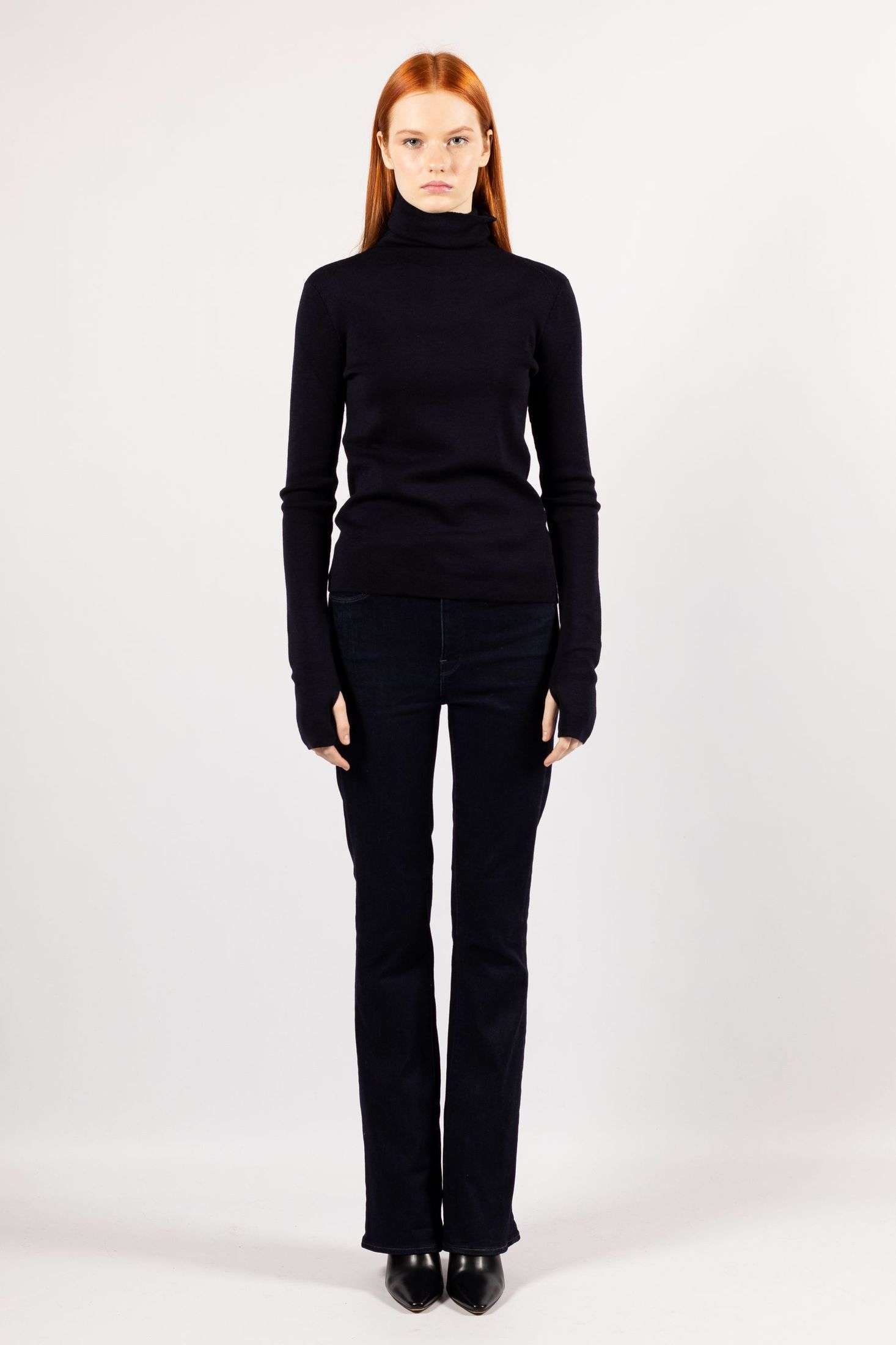 Admire the fashionable choice of a young lady wearing the ADA turtleneck in a captivating navy color.