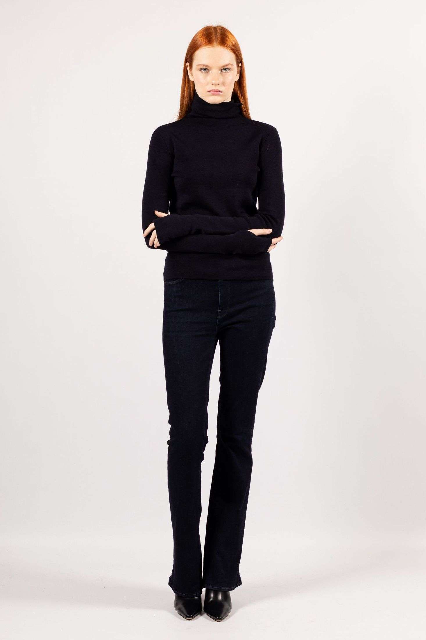 Revel in the style statement made by a young woman in the navy ADA fine knit turtleneck.
