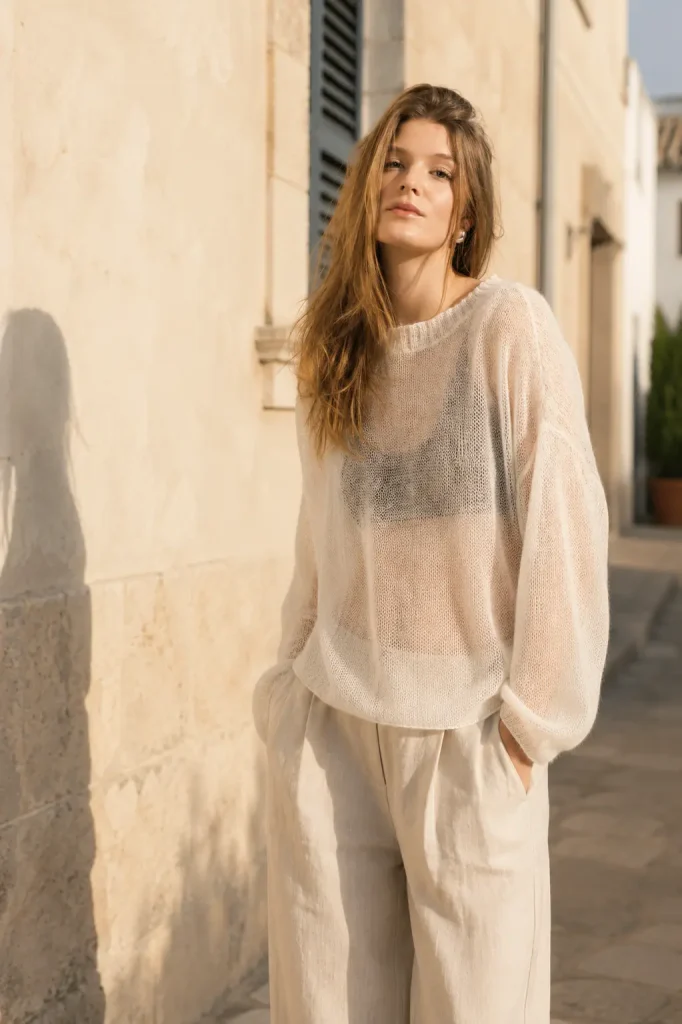 Woman wearing a lightweight white mohair sweater in summer